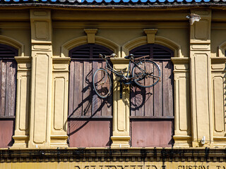 Old buildings Sino Portuguese style in Phuket town Thailand. architectural style is European mixed with Chinese modern. Window and bicycle