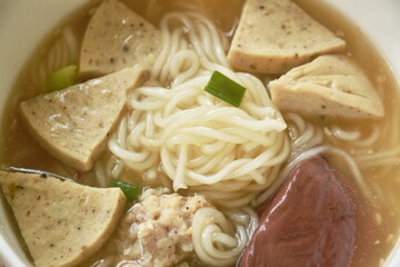 Vietnamese rice noodles or Pho with slice sausage and chop pork in soup on bowl