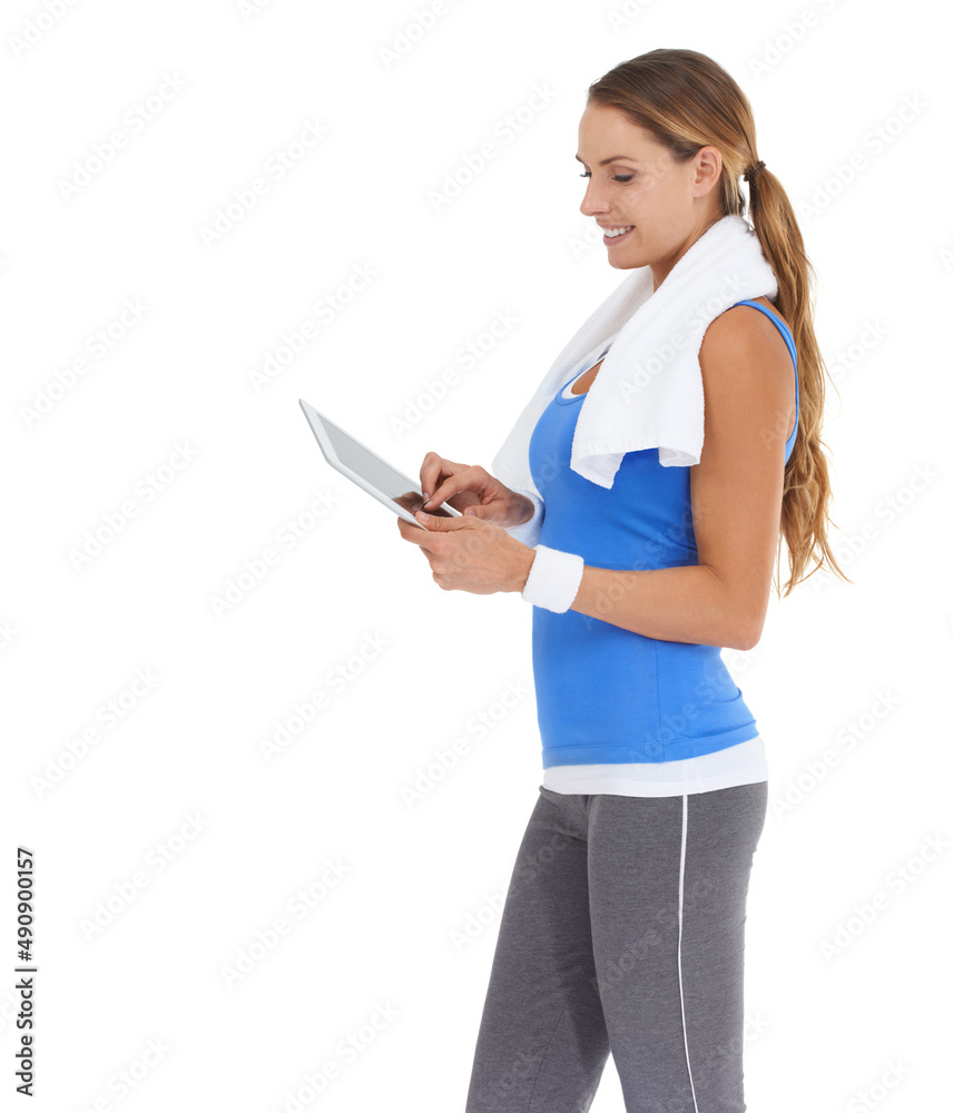 Wall mural My status is now Fit and feeling great. Young woman in sportswear using a tablet while isolated on white.