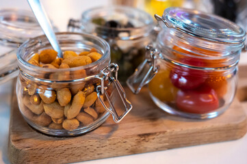 Glass jars with healthy party snacks served in bar, tasty appetisers