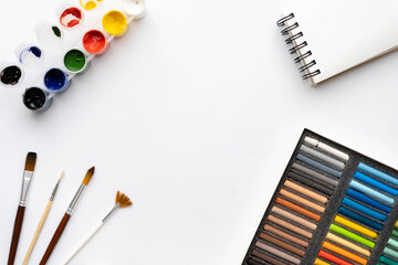 Flat composition set of artistic tools. Brushes, paints, pencils, pastels for drawing. Place for text.