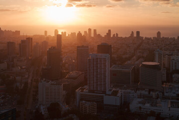 Orange sunset in Tel Aviv city. Aerial view above