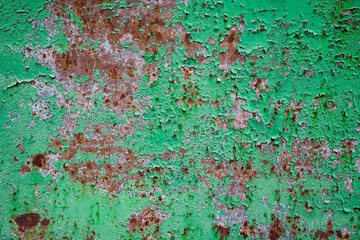 closeup of an old peeling green paint on a metal surface. Abstract industrial background