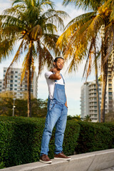 Photo of a handsome African American male model in park with palms in background