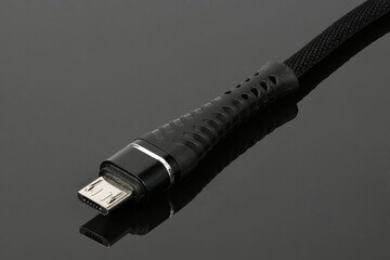 Closeup of an USB connector on black acrylic background.