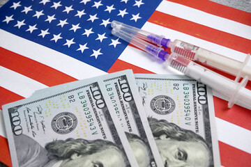 american flag, syringes with coronavirus vaccine and money, money for purchase and production vaccine