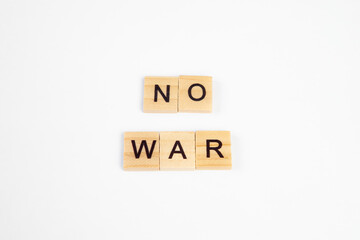 phrase no war is laid out of wooden squares isolated on white background. The concept of peace, war in Ukraine