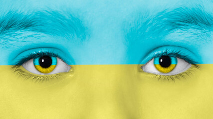 Teen Girl's eyes and face are toned in colors of Ukrainian Flag. Stop the war in Ukraine concept. High-quality photo