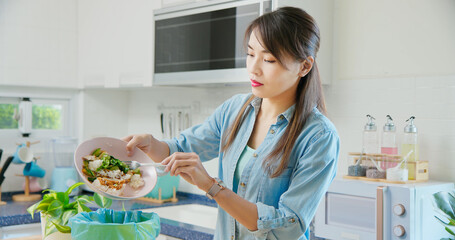 woman is scraping food leftovers