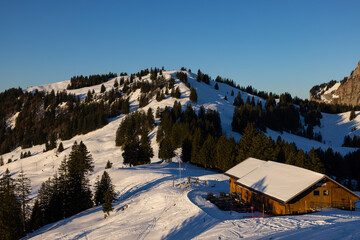 Super panorama of a Swiss mountain ridge that is illuminated by the sun at sunrise. Beautiful wintry and snowy landscape. what a view.