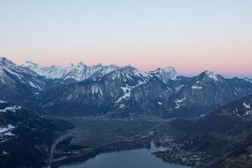 Naklejka na ściany i meble What a wonderful sunrise in the Swiss Alps, in the canton of Glarus to be exact. The sky turns red and pink over the mountain peaks.