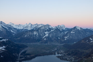 Fototapeta na wymiar What a wonderful sunrise in the Swiss Alps, in the canton of Glarus to be exact. The sky turns red and pink over the mountain peaks.
