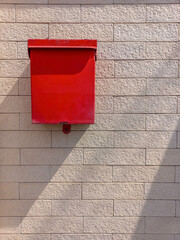 Red mailbox on the wall, outdoor