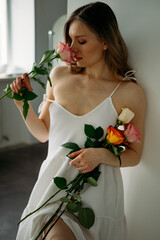 Beautiful woman in white dress with flowers