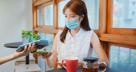 woman pay by smartphone