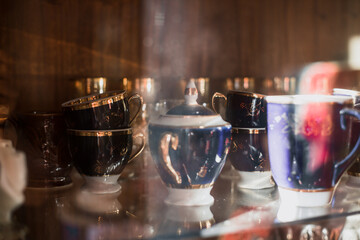 Antique old service. Old service in a sideboard at a summer cottage. collection of tea porcelain service, cobalt gilding, service behind the flow