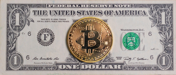 Gold coin bitcoin on the background of the american dollar