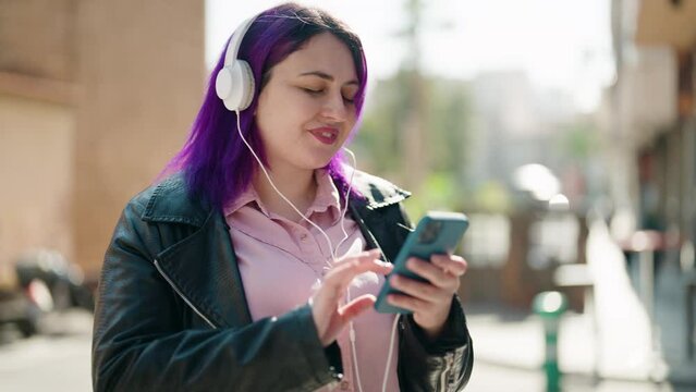 Young plus size woman smiling confident listening to music at street