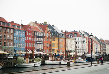 Fototapeta na wymiar Streets of Copenhagen, Denmark. Houses and streets of Copenhagen. City landscape. Traditional architecture in Copenhagen, Denmark. colorful houses on the famous Nyhavn street