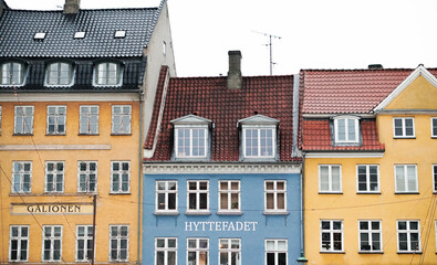 Fototapeta na wymiar Streets of Copenhagen, Denmark. Houses and streets of Copenhagen. City landscape. Traditional architecture in Copenhagen, Denmark