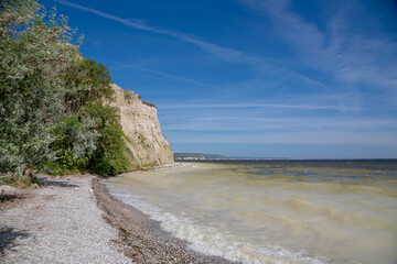 Bank of the Volga River. The surf line, the high shore and the water muddy with limestone.