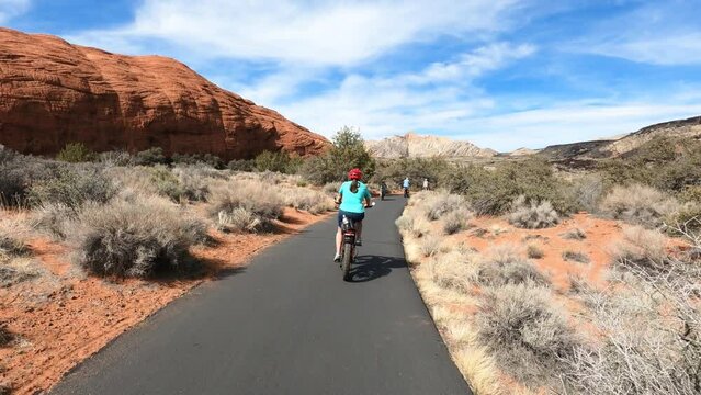 Woman riding path Bike path trail desert southern Utah POV. Bicycle trails in St George southern Utah in desert and red rock landscape. Healthy Exercise on paths in mountains, valley.