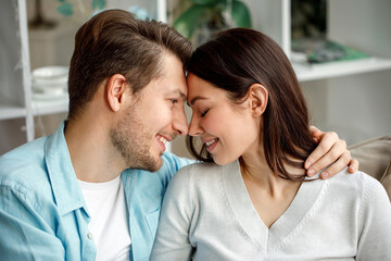 Portrait of a beautiful beloved couple. A guy and a girl hug each other and smile. On a white background