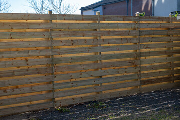 New wooden build fence in a garden in Hoofddorp The Netherlands after storm damage taken by storm Corrie, Eunice, Dudley and Franklin. 