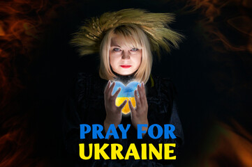Pray for Ukraine, Stand with Ukraine. Beautiful Ukrainian woman in wreath of wheat holds a heart in the national colors of Ukraine in her hands. Stop war against Ukraine 