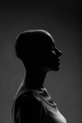 emotional studio portrait of a young attractive bald girl black and white image