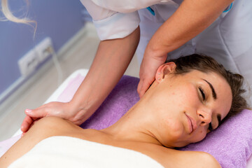 Fototapeta na wymiar Facial massage. A woman is given a massage in a beauty salon. Close-up.