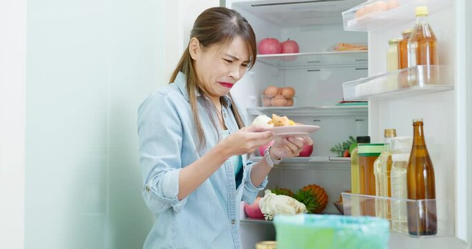 woman is pouring food waste