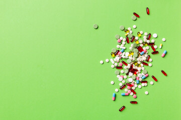 assorted pills and tablets top border over colored background. Many different pills and space for text on colorful background, top view