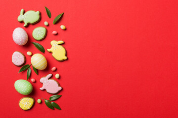 holiday preparation Multi colors Easter eggs with cookies on colored background . Pastel color Easter eggs. holiday concept with copy space