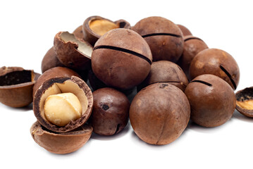 Macadamia isolate. Macadamia nuts lie in a heap on a white background