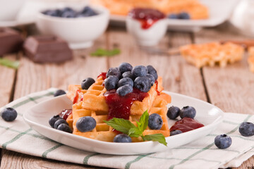 Waffles with blueberries and jam. 