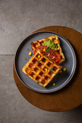 Belgian cheese waffles with guacamole, tomato and syrup