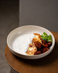 Cottage cheese pancakes, caramel cream sauce with poppy seeds and basil, fresh caramelized plums ( syrniki )