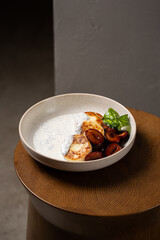 Cottage cheese pancakes, caramel cream sauce with poppy seeds and basil, fresh caramelized plums ( syrniki )