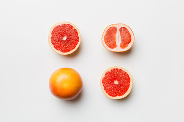 fresh Fruit grapefruit with Juicy grapefruit slices on colored background. Top view. Copy Space. creative summer concept. Half of citrus in minimal flat lay with copy space