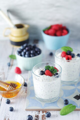Greek yogurt in glasses with berries and quinoa