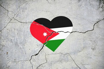 The symbol of the national flag of Jordan in the form of a heart on a cracked concrete wall.