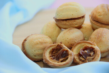 cookies in the form of nuts with condensed milk on a blue background