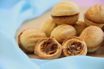 cookies in the form of nuts with condensed milk on a blue background