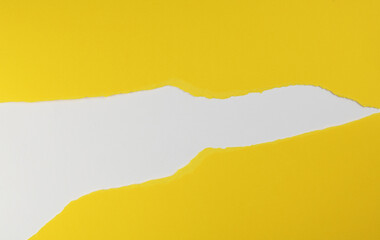 Yellow paper with torn edges isolated with white colored paper background inside. Good paper texture