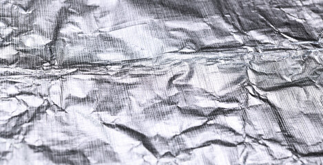 Foil silver crumpled metal aluminum texture background surface decoration backdrop design photo.