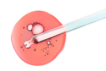 Liquid red pipette gel or serum on blue glass of microscop background