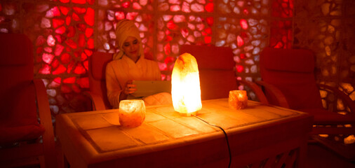 Beautiful woman enjoying salt therapy and beauty treatment in beauty spa.