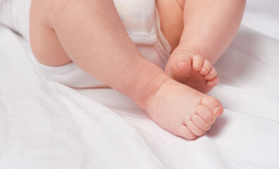 Fototapeta na wymiar These feet will walk into the future. Cropped shot of a baby boys legs and feet in a studio.