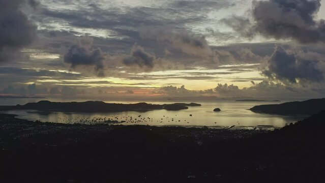 .aerial view beautiful yellow sunrise above archipelago Phuket..beautiful moving cloud in golden sky at sunrise..4k stock footage video in travel concept.